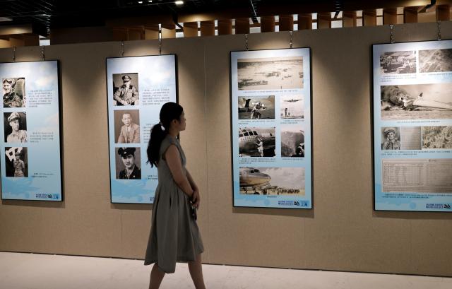 (250708) -- SHANGHAI, July 8, 2025 (Xinhua) -- A visitor views exhibits at the Flying Tigers Photo Exhibition in Shanghai, east China, July 8, 2025. Themed "Remembering heroes and creating the future together," the exhibition opened here on Tuesday, showcasing hundreds of valuable photos as well as other items of historic significance contributed by veterans of the Flying Tigers. (Xinhua/Fang Zhe)