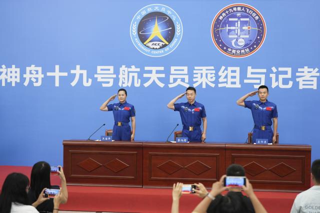(250709) -- BEIJING, July 9, 2025 (Xinhua) -- Astronauts Cai Xuzhe (C), Song Lingdong (R) and Wang Haoze from China's Shenzhou-19 crewed mission salute during a press conference in Beijing, capital of China, July 9, 2025. The three astronauts met the press on Wednesday, their first public appearance after returning to Earth in April. (Xinhua/Li Yanchen)