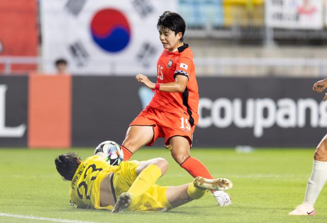 (250709) -- SUWON, July 9, 2025 (Xinhua) -- Jeon Yugyeong of South Korea is tackled by China's goalkeeper Pan Hongyan (L) during the women's football match between China and South Korea at the EAFF (East Asian Football Federation) E-1 Football Championship 2025 Final in Suwon, South Korea, July 9, 2025. (Photo by Jun Hyosang/Xinhua)