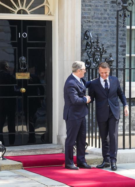 (250710) -- LONDON, July 10, 2025 (Xinhua) -- British Prime Minister Keir Starmer (L) welcomes French President Emmanuel Macron at 10 Downing Street in London, Britain, on July 10, 2025. British Prime Minister Keir Starmer said on Thursday that Britain and France have signed a new deal to allow the two countries to coordinate their nuclear deterrents for the first time. (Xinhua/Wu Lu)