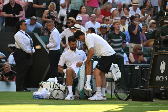 (250712) -- LONDON, July 12, 2025 (Xinhua) -- Novak Djokovic (front L) gets medical treatments during the men's singles semifinal match between Jannik Sinner of Italy and Novak Djokovic of Serbia at the Wimbledon Tennis Championships in London, Britain, July 11, 2025. (Xinhua/Zhao Dingzhe)