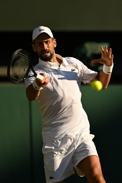 (250712) -- LONDON, July 12, 2025 (Xinhua) -- Novak Djokovic hits a return during the men's singles semifinal match between Jannik Sinner of Italy and Novak Djokovic of Serbia at the Wimbledon Tennis Championships in London, Britain, July 11, 2025. (Xinhua/Zhao Dingzhe)