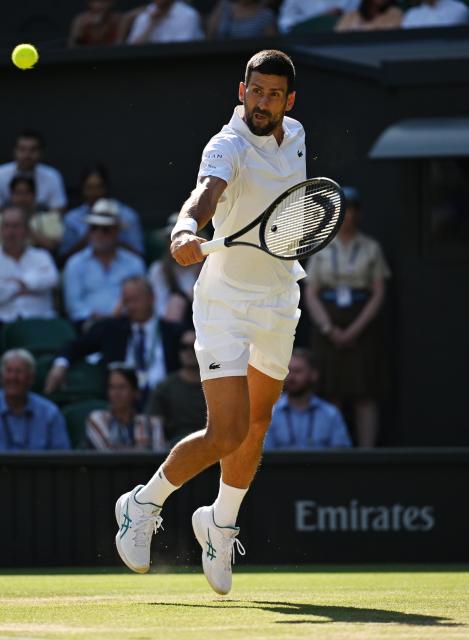 (250712) -- LONDON, July 12, 2025 (Xinhua) -- Novak Djokovic hits a return during the men's singles semifinal match between Jannik Sinner of Italy and Novak Djokovic of Serbia at the Wimbledon Tennis Championships in London, Britain, July 11, 2025. (Xinhua/Zhao Dingzhe)
