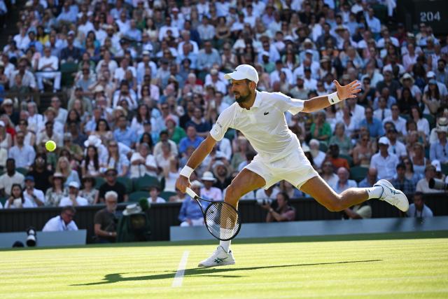 (250712) -- LONDON, July 12, 2025 (Xinhua) -- Novak Djokovic hits a return during the men's singles semifinal match between Jannik Sinner of Italy and Novak Djokovic of Serbia at the Wimbledon Tennis Championships in London, Britain, July 11, 2025. (Xinhua/Zhao Dingzhe)