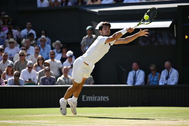 (250712) -- LONDON, July 12, 2025 (Xinhua) -- Carlos Alcaraz hits a return during the men's singles semifinal match between Carlos Alcaraz of Spain and Taylor Fritz of the United States at the Wimbledon Tennis Championships in London, Britain, July 11, 2025. (Xinhua/Zhao Dingzhe)