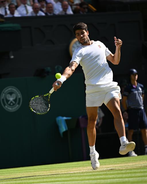 (250712) -- LONDON, July 12, 2025 (Xinhua) -- Carlos Alcaraz hits a return during the men's singles semifinal match between Carlos Alcaraz of Spain and Taylor Fritz of the United States at the Wimbledon Tennis Championships in London, Britain, July 11, 2025. (Xinhua/Zhao Dingzhe)