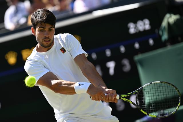 (250712) -- LONDON, July 12, 2025 (Xinhua) -- Carlos Alcaraz hits a return during the men's singles semifinal match between Carlos Alcaraz of Spain and Taylor Fritz of the United States at the Wimbledon Tennis Championships in London, Britain, July 11, 2025. (Xinhua/Zhao Dingzhe)