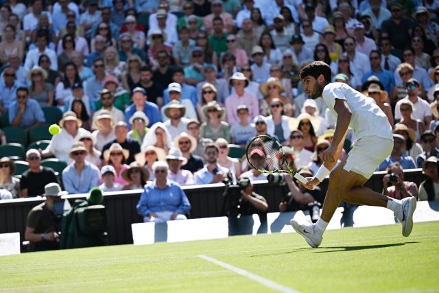 (250712) -- LONDON, July 12, 2025 (Xinhua) -- Carlos Alcaraz hits a return during the men's singles semifinal match between Carlos Alcaraz of Spain and Taylor Fritz of the United States at the Wimbledon Tennis Championships in London, Britain, July 11, 2025. (Xinhua/Zhao Dingzhe)