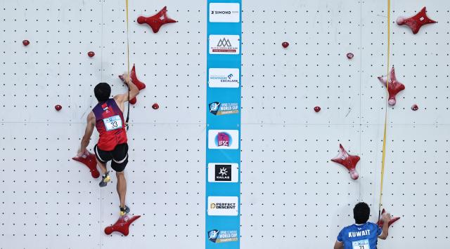(250712) -- CHARMONIX, July 12, 2025 (Xinhua) -- Long Jianguo (L) of China competes during the men's Speed Qualification of sport climbing at the 2025 IFSC Climbing World Cup Speed-Lead in Charmonix, France, July 11, 2025. (Xinhua/Gao Jing)