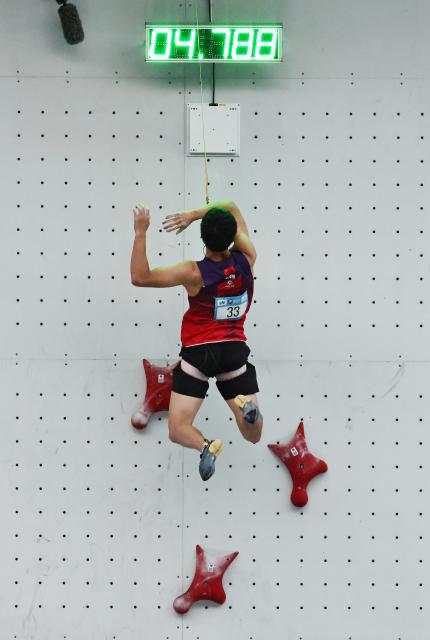 (250712) -- CHARMONIX, July 12, 2025 (Xinhua) -- Long Jianguo of China competes during the men's Speed Qualification of sport climbing at the 2025 IFSC Climbing World Cup Speed-Lead in Charmonix, France, July 11, 2025. (Xinhua/Gao Jing)