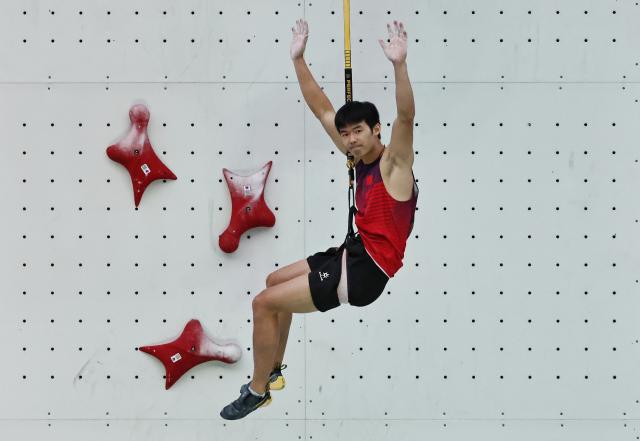 (250712) -- CHARMONIX, July 12, 2025 (Xinhua) -- Long Jianguo of China reacts during the men's Speed Qualification of sport climbing at the 2025 IFSC Climbing World Cup Speed-Lead in Charmonix, France, July 11, 2025. (Xinhua/Gao Jing)