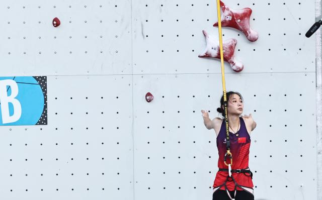 (250712) -- CHAMONIX, July 12, 2025 (Xinhua) -- Zhou Yafei of China reacts during the women's Speed Qualification of sport climbing at the 2025 IFSC Climbing World Cup Speed-Lead in Charmonix, France, July 11, 2025. (Xinhua/Gao Jing)
