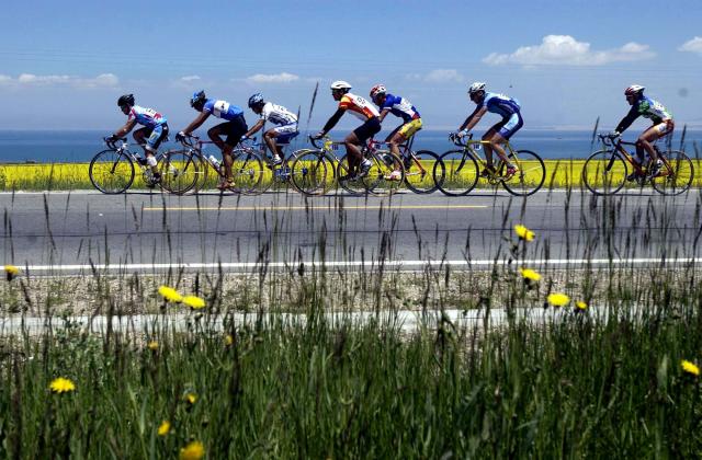 (250712) -- XINING, July 12, 2025 (Xinhua) -- Cyclists compete during the Stage 5 of the 1st Tour of Qinghai Lake cycling race, northwest China's Qinghai Province, July 31, 2002. (Xinhua/Hou Deqiang)