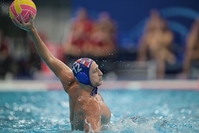 (250712) -- SINGAPORE, July 12, 2025 (Xinhua) -- Konstantin Kharkov of Croatia competes during the men's water polo preliminary match between China and Croatia at World Aquatics Championship 2025 in Singapore on July 12, 2025. (Xinhua/Then Chih Wey)