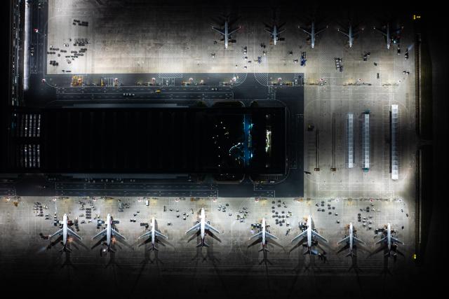 (250712) -- EZHOU, July 12, 2025 (Xinhua) -- This photo taken on July 11, 2025 shows a view of the apron at Ezhou Huahu International Airport in Ezhou, central China's Hubei Province. Brightly lit during the night, Ezhou Huahu International Airport, China's first cargo-focused airport, is kept awake handling cargo from home and abroad. Starting operation in July 2022, the airport, owning a 750,000-square meter cargo transfer center with parcel sorting lines adding up to 52 kilometers, is now running 59 domestic cargo routes in addition to 45 international routes. (Xinhua/Xiao Yijiu)