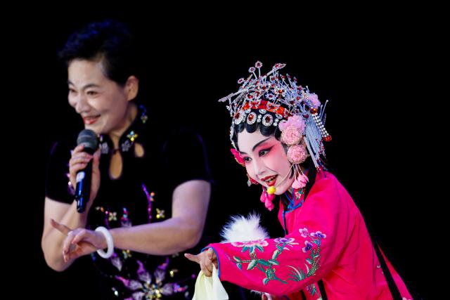(250712) -- BEIJING, July 12, 2025 (Xinhua) -- A kid performs traditional opera with an artist at a theater in Tianjin, north China, July 12, 2025. Children across the country are enriching their summer vacations through colorful activities. (Photo by Du Penghui/Xinhua)