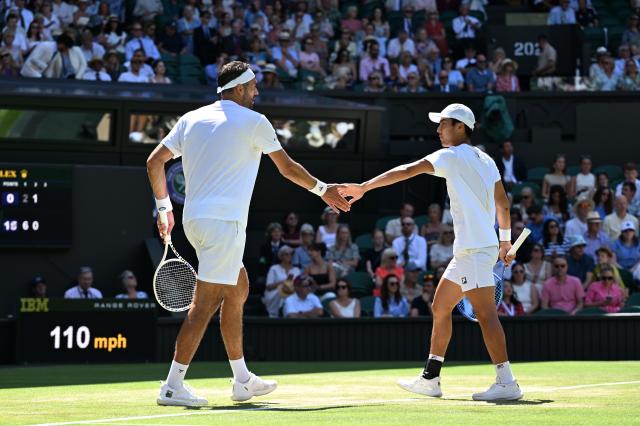 (250712) -- LONDON, July 12, 2025 (Xinhua) -- Rinky Hijikata/David Pel (L) react during the men's doubles final between Rinky Hijikata (Australia)/David Pel (the Netherlands) and Julian Cash/Lloyd Glasspool of Britain at the Wimbledon Tennis Championships in London, Britain, July 12, 2025. (Xinhua/Zhao Dingzhe)