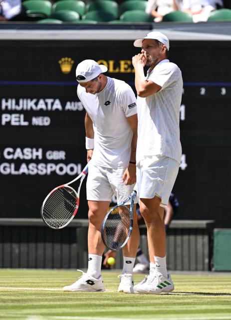 (250712) -- LONDON, July 12, 2025 (Xinhua) -- Julian Cash (L)/Lloyd Glasspool react during the men's doubles final between Rinky Hijikata (Australia)/David Pel (the Netherlands) and Julian Cash/Lloyd Glasspool of Britain at the Wimbledon Tennis Championships in London, Britain, July 12, 2025. (Xinhua/Zhao Dingzhe)