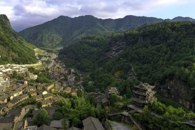 (250712) -- SHANGRAO, July 12, 2025 (Xinhua) -- An aerial drone photo shows the Wangxian Valley Scenic Spot in Wangxian Township of Shangrao City, east China's Jiangxi Province, July 12, 2025. Once a granite mining quarry, Wangxian Valley has been transformed into a popular tourist destination following a government ban on disorderly mining, with its natural cliffs creatively repurposed into attractions such as cliffside hotels, cliff skywalks and waterfalls.
   Thanks to its ethereal and mystical views, this valley has garnered wide attention. In the first quarter of 2025, the valley hosted 615,800 visitors, generating 120 million yuan (about 16.73 million U.S. dollars) in revenue.
   This tourism boom has also benefited surrounding villagers. Many of them have opened shops and restaurants within the scenic area, while others have found relevent jobs. (Xinhua/Liu Jinhai)
