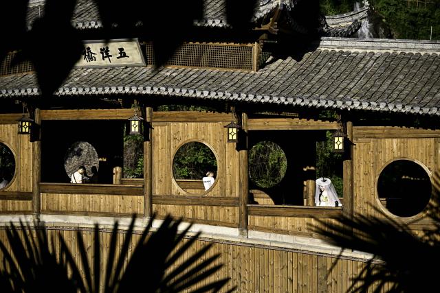(250712) -- SHANGRAO, July 12, 2025 (Xinhua) -- Tourists visit the Wangxian Valley Scenic Spot in Wangxian Township of Shangrao City, east China's Jiangxi Province, July 11, 2025. Once a granite mining quarry, Wangxian Valley has been transformed into a popular tourist destination following a government ban on disorderly mining, with its natural cliffs creatively repurposed into attractions such as cliffside hotels, cliff skywalks and waterfalls.
   Thanks to its ethereal and mystical views, this valley has garnered wide attention. In the first quarter of 2025, the valley hosted 615,800 visitors, generating 120 million yuan (about 16.73 million U.S. dollars) in revenue.
   This tourism boom has also benefited surrounding villagers. Many of them have opened shops and restaurants within the scenic area, while others have found relevent jobs. (Xinhua/Liu Jinhai)