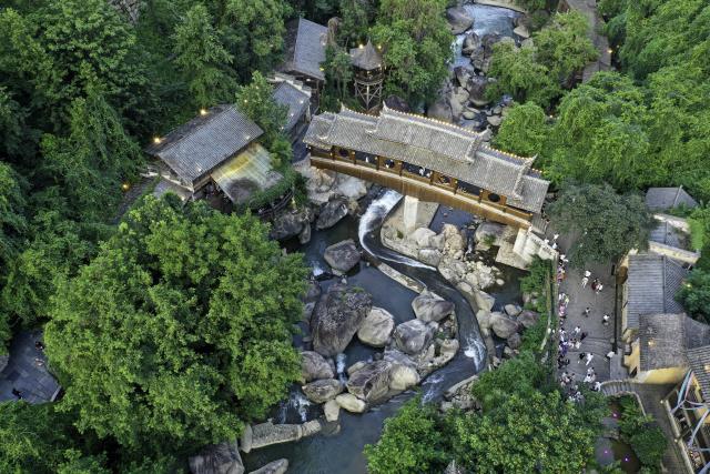 (250712) -- SHANGRAO, July 12, 2025 (Xinhua) -- An aerial drone photo shows the Wangxian Valley Scenic Spot in Wangxian Township of Shangrao City, east China's Jiangxi Province, July 11, 2025. Once a granite mining quarry, Wangxian Valley has been transformed into a popular tourist destination following a government ban on disorderly mining, with its natural cliffs creatively repurposed into attractions such as cliffside hotels, cliff skywalks and waterfalls.
   Thanks to its ethereal and mystical views, this valley has garnered wide attention. In the first quarter of 2025, the valley hosted 615,800 visitors, generating 120 million yuan (about 16.73 million U.S. dollars) in revenue.
   This tourism boom has also benefited surrounding villagers. Many of them have opened shops and restaurants within the scenic area, while others have found relevent jobs. (Xinhua/Liu Jinhai)