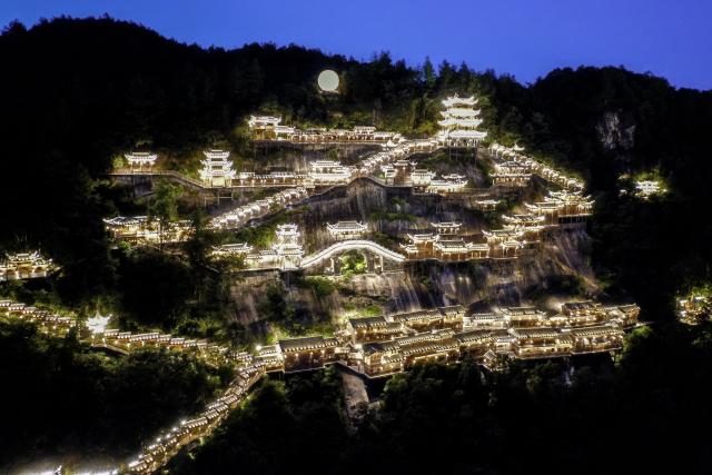 (250712) -- SHANGRAO, July 12, 2025 (Xinhua) -- An aerial drone photo shows the Wangxian Valley Scenic Spot in Wangxian Township of Shangrao City, east China's Jiangxi Province, July 11, 2025. Once a granite mining quarry, Wangxian Valley has been transformed into a popular tourist destination following a government ban on disorderly mining, with its natural cliffs creatively repurposed into attractions such as cliffside hotels, cliff skywalks and waterfalls.
   Thanks to its ethereal and mystical views, this valley has garnered wide attention. In the first quarter of 2025, the valley hosted 615,800 visitors, generating 120 million yuan (about 16.73 million U.S. dollars) in revenue.
   This tourism boom has also benefited surrounding villagers. Many of them have opened shops and restaurants within the scenic area, while others have found relevent jobs. (Xinhua/Liu Jinhai)