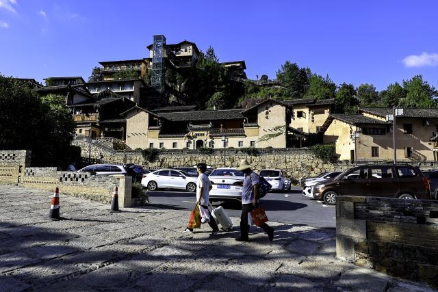 (250712) -- SHANGRAO, July 12, 2025 (Xinhua) -- Tourists arrive at the Wangxian Valley Scenic Spot in Wangxian Township of Shangrao City, east China's Jiangxi Province, July 11, 2025. Once a granite mining quarry, Wangxian Valley has been transformed into a popular tourist destination following a government ban on disorderly mining, with its natural cliffs creatively repurposed into attractions such as cliffside hotels, cliff skywalks and waterfalls.
   Thanks to its ethereal and mystical views, this valley has garnered wide attention. In the first quarter of 2025, the valley hosted 615,800 visitors, generating 120 million yuan (about 16.73 million U.S. dollars) in revenue.
   This tourism boom has also benefited surrounding villagers. Many of them have opened shops and restaurants within the scenic area, while others have found relevent jobs. (Xinhua/Liu Jinhai)