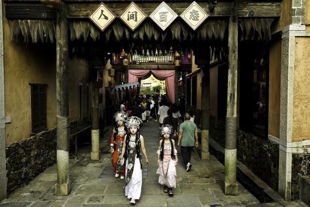 (250712) -- SHANGRAO, July 12, 2025 (Xinhua) -- Tourists visit the Wangxian Valley Scenic Spot in Wangxian Township of Shangrao City, east China's Jiangxi Province, July 11, 2025. Once a granite mining quarry, Wangxian Valley has been transformed into a popular tourist destination following a government ban on disorderly mining, with its natural cliffs creatively repurposed into attractions such as cliffside hotels, cliff skywalks and waterfalls.
   Thanks to its ethereal and mystical views, this valley has garnered wide attention. In the first quarter of 2025, the valley hosted 615,800 visitors, generating 120 million yuan (about 16.73 million U.S. dollars) in revenue.
   This tourism boom has also benefited surrounding villagers. Many of them have opened shops and restaurants within the scenic area, while others have found relevent jobs. (Xinhua/Liu Jinhai)