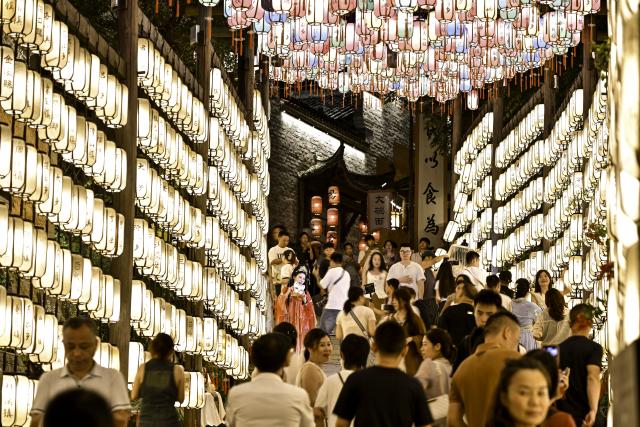 (250712) -- SHANGRAO, July 12, 2025 (Xinhua) -- Tourists visit the Wangxian Valley Scenic Spot in Wangxian Township of Shangrao City, east China's Jiangxi Province, July 11, 2025. Once a granite mining quarry, Wangxian Valley has been transformed into a popular tourist destination following a government ban on disorderly mining, with its natural cliffs creatively repurposed into attractions such as cliffside hotels, cliff skywalks and waterfalls.
   Thanks to its ethereal and mystical views, this valley has garnered wide attention. In the first quarter of 2025, the valley hosted 615,800 visitors, generating 120 million yuan (about 16.73 million U.S. dollars) in revenue.
   This tourism boom has also benefited surrounding villagers. Many of them have opened shops and restaurants within the scenic area, while others have found relevent jobs. (Xinhua/Liu Jinhai)