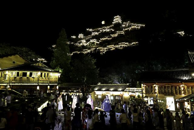 (250712) -- SHANGRAO, July 12, 2025 (Xinhua) -- Tourists visit the Wangxian Valley Scenic Spot in Wangxian Township of Shangrao City, east China's Jiangxi Province, July 11, 2025. Once a granite mining quarry, Wangxian Valley has been transformed into a popular tourist destination following a government ban on disorderly mining, with its natural cliffs creatively repurposed into attractions such as cliffside hotels, cliff skywalks and waterfalls.
   Thanks to its ethereal and mystical views, this valley has garnered wide attention. In the first quarter of 2025, the valley hosted 615,800 visitors, generating 120 million yuan (about 16.73 million U.S. dollars) in revenue.
   This tourism boom has also benefited surrounding villagers. Many of them have opened shops and restaurants within the scenic area, while others have found relevent jobs. (Xinhua/Liu Jinhai)
