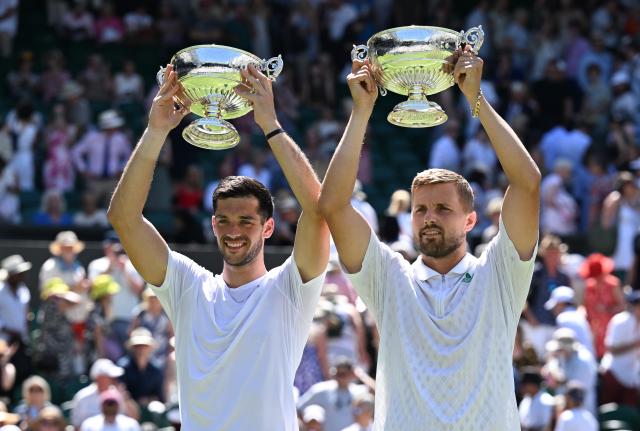 (250712) -- LONDON, July 12, 2025 (Xinhua) -- Julian Cash (L)/Lloyd Glasspool pose with their trophies during the awarding ceremony after the men's doubles final between Rinky Hijikata (Australia)/David Pel (the Netherlands) and Julian Cash/Lloyd Glasspool of Britain at the Wimbledon Tennis Championships in London, Britain, July 12, 2025. (Xinhua/Zhao Dingzhe)