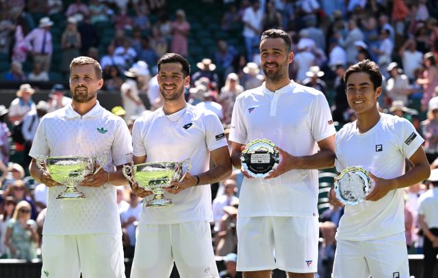(250712) -- LONDON, July 12, 2025 (Xinhua) -- Rinky Hijikata (1st R)/David Pel (2nd R) and Julian Cash (2nd L)/Lloyd Glasspool pose with their trophies during the awarding ceremony after the men's doubles final between Rinky Hijikata (Australia)/David Pel (the Netherlands) and Julian Cash/Lloyd Glasspool of Britain at the Wimbledon Tennis Championships in London, Britain, July 12, 2025. (Xinhua/Zhao Dingzhe)
