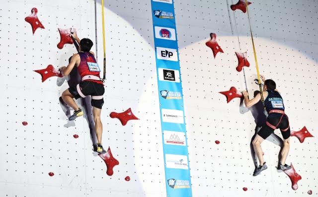 (250713) -- CHARMONIX, July 13, 2025 (Xinhua) -- Long Jianguo (L) of China competes during the men's Speed quarterfinal of sport climbing at the 2025 IFSC Climbing World Cup Speed-Lead in Charmonix, France, July 12, 2025. (Xinhua/Gao Jing)