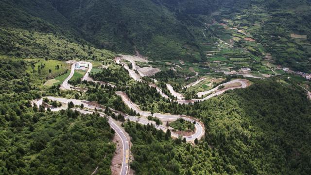(250713) -- ZHOUQU(GANSU), July 13, 2025 (Xinhua) -- This aerial drone photo taken on July 12, 2025 shows a driveway in Zhouqu County, Gannan Tibetan Autonomous Prefecture, northwest China's Gansu Province. (Xinhua/Chen Bin)