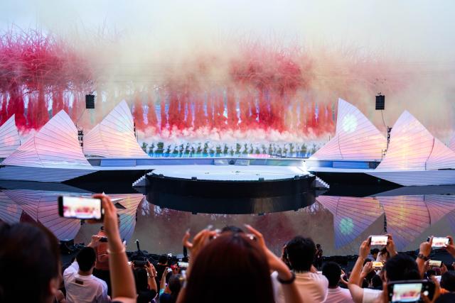 (250713) -- CHANGSHA, July 13, 2025 (Xinhua) -- Tourists take photos during a creative fireworks show in Liuyang City, central China's Hunan Province, July 12, 2025. Liuyang, a small city known as China's "fireworks capital," has organized 26 creative fireworks events in the first half of 2025. These events have attracted over 1.5 million tourists in total, stimulating consumer spending of nearly 4 billion yuan (about 558 million U.S. dollars). (Xinhua/Chen Sihan)