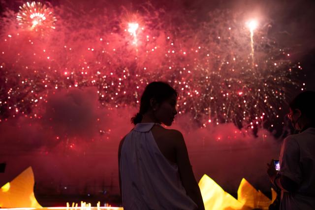 (250713) -- CHANGSHA, July 13, 2025 (Xinhua) -- Tourists enjoy a creative fireworks show in Liuyang City, central China's Hunan Province, July 12, 2025. Liuyang, a small city known as China's "fireworks capital," has organized 26 creative fireworks events in the first half of 2025. These events have attracted over 1.5 million tourists in total, stimulating consumer spending of nearly 4 billion yuan (about 558 million U.S. dollars). (Xinhua/Chen Sihan)