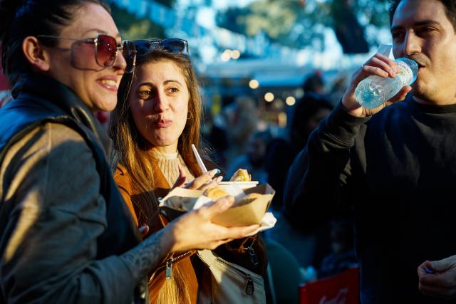 (250713) -- BUENOS AIRES, July 13, 2025 (Xinhua) -- People enjoy foods at a food festival in Buenos Aires, Argentina, on July 12, 2025. A two-day food festival was held to celebrate Argentina's Independence Day in Buenos Aires. (Xinhua/Meng Dingbo)