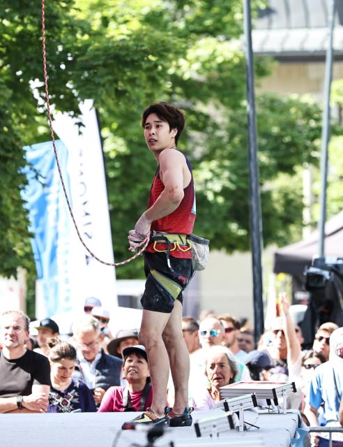 (250713) -- CHARMONIX, July 13, 2025 (Xinhua) -- Pan Yufei of China reacts after the men's lead semifinal of sport climbing at the 2025 IFSC Climbing World Cup Speed-Lead in Charmonix, France, July 13, 2025. (Xinhua/Gao Jing)