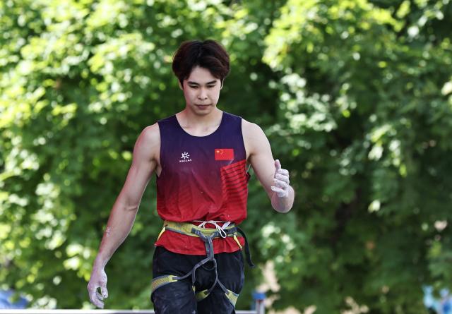 (250713) -- CHARMONIX, July 13, 2025 (Xinhua) -- Pan Yufei of China reacts after the men's lead semifinal of sport climbing at the 2025 IFSC Climbing World Cup Speed-Lead in Charmonix, France, July 13, 2025. (Xinhua/Gao Jing)