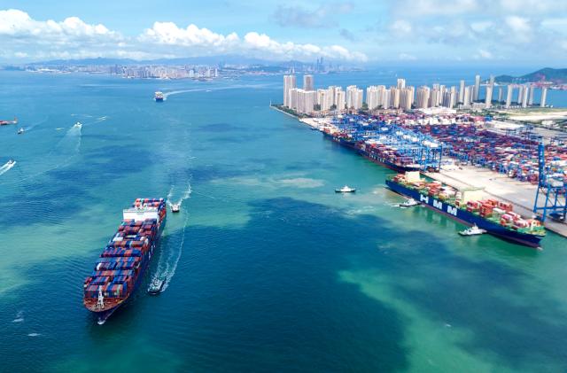 (250713) -- BEIJING, July 13, 2025 (Xinhua) -- This aerial drone photo taken on July 8, 2025 shows container ships entering Qingdao Port in Qingdao, east China's Shandong Province. China's maritime industry now handles nearly one-third of global maritime shipping volume, according to the 2025 China Maritime Day Forum held in the coastal town of Boao in south China's Hainan Province on Friday. China's booming marine economy is driving sustained and stable growth in global trade and development. (Photo by Zhang Jingang/Xinhua)