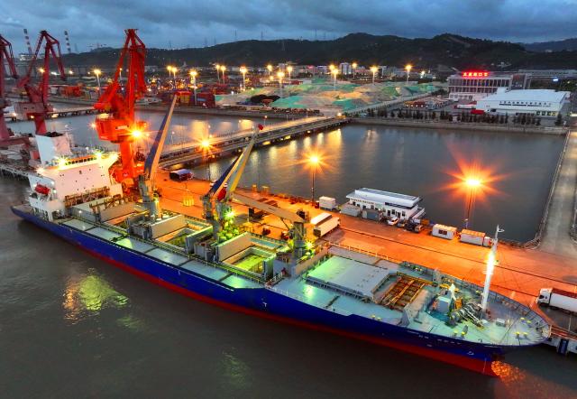 (250713) -- BEIJING, July 13, 2025 (Xinhua) -- This aerial photo taken on July 9, 2025 shows a New Zealand cargo ship unloading at Damaiyu Port in Yuhuan City, east China's Zhejiang Province. China's maritime industry now handles nearly one-third of global maritime shipping volume, according to the 2025 China Maritime Day Forum held in the coastal town of Boao in south China's Hainan Province on Friday. China's booming marine economy is driving sustained and stable growth in global trade and development. (Photo by Duan Junli/Xinhua)