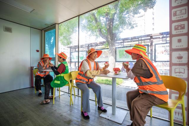 (250713) -- BEIJING, July 13, 2025 (Xinhua) -- Sanitation workers have watermelon as a summer refreshment at a devoted lounge in Xinghua City of east China's Jiangsu City, July 13, 2025. A heatwave is sweeping multiple regions in China, prompting authorities to roll out measures to ensure job safety and stable production. (Photo by Zhou Shegen/Xinhua)