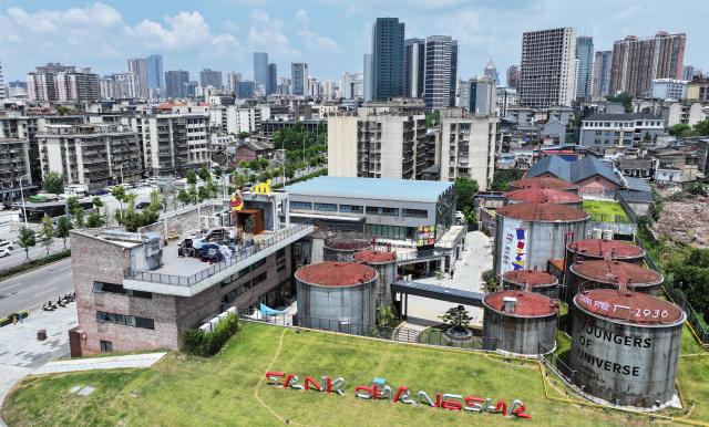(250713) -- CHANGSHA, July 13, 2025 (Xinhua) -- An aerial drone photo shows an obsolete oil depot in Changsha, central China's Hunan Province, July 13, 2025. In Tianxin District of Changsha City, 12 weathered oil tanks stand along the Xiangjiang River. This site formerly served as the oil depot for the city, witnessing an olden time when citizens fetch edible oil with ration coupons. The facility was largely left unused since the 1990s.
    This July saw the reopening of this industrial heritage, with oil tanks and auxiliary facilities transformed into vibrant cafes, exhibition halls, art stores, among others, featuring a blend of industrial design and diverse consumer experiences that attract both residents and tourists. (Xinhua/Chen Zhenhai)