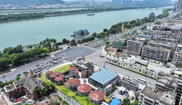 (250713) -- CHANGSHA, July 13, 2025 (Xinhua) -- An aerial drone photo shows an obsolete oil depot in Changsha, central China's Hunan Province, July 13, 2025. In Tianxin District of Changsha City, 12 weathered oil tanks stand along the Xiangjiang River. This site formerly served as the oil depot for the city, witnessing an olden time when citizens fetch edible oil with ration coupons. The facility was largely left unused since the 1990s.
    This July saw the reopening of this industrial heritage, with oil tanks and auxiliary facilities transformed into vibrant cafes, exhibition halls, art stores, among others, featuring a blend of industrial design and diverse consumer experiences that attract both residents and tourists. (Xinhua/Chen Zhenhai)
