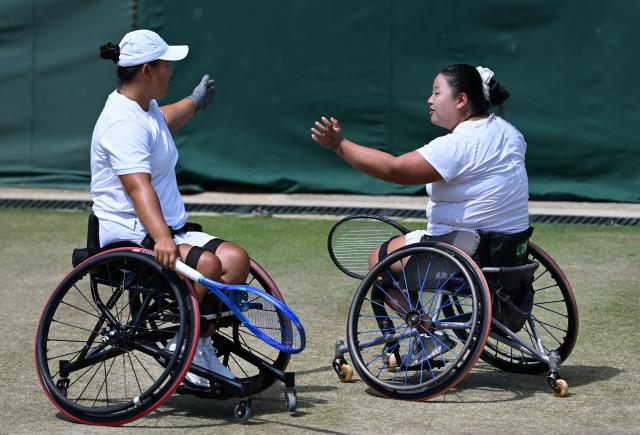 (250713) -- LONDON, July 13, 2025 (Xinhua) -- Li Xiaohui/Wang Ziying (R) react during the women's wheelchair doubles final between Li Xiaohui/Wang Ziying of China and Angelica Bernal (Colombia)/Ksenia Chasteau (France) at the Wimbledon Tennis Championships in London, Britain, July 13, 2025. (Xinhua/Zhao Dingzhe)