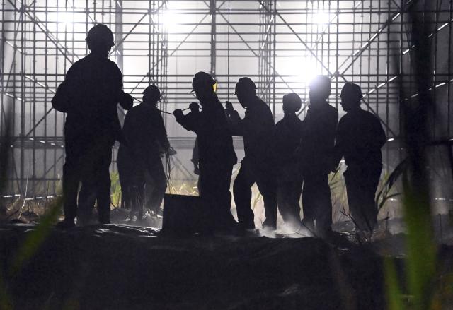 (250713) -- MINFENG, July 13, 2025 (Xinhua) -- Night-shift workers operate on the extra-high voltage power transmission loop around the Tarim Basin over the Hotan-Ruoqiang railway in northwest China's Xinjiang Uygur Autonomous Region, early July 10, 2025. China has finished construction of a 4,197-km extra-high voltage power transmission loop around the Tarim Basin, home to the country's largest desert, marking a major infrastructure milestone in southern Xinjiang Uygur Autonomous Region.
   The final section of the 750-kilovolt (kV) loop, now the country's largest of its kind, was connected on Sunday, capping a 15-year project involving nine substations and nearly 10,000 steel towers, according to a subsidiary of State Grid Xinjiang Electric Power Co., Ltd., which constructed the project.
   The transmission line passes through extreme terrain, from the shifting sands of the desert to the high altitudes of the Kunlun Mountains.
   Chen Lin arrived in March this year at the southern edge of the Taklimakan Desert, where he, side by side with over 40 colleagues, accomplished part of the transmission line construction work despite sandy gusts and scorching temperature. (Photo by Ma Yuan/Xinhua)