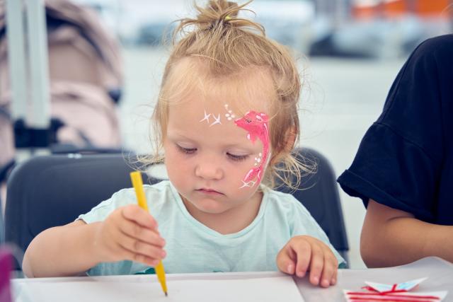 (250714) -- BEIJING, July 14, 2025 (Xinhua) -- A girl with a dolphin pattern painted on her face attends a Fisherman's Day celebration in Vladivostok, Russia, July 13, 2025. The Fisherman's Day is observed across Russia on the second Sunday of July. (Photo by Guo Feizhou/Xinhua)