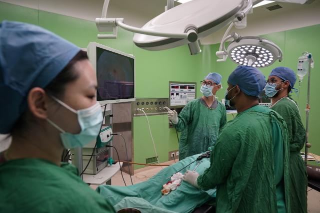 (250715) -- NOUAKCHOTT, July 15, 2025 (Xinhua) -- Doctor Lyu Jiayu (2nd L) and nurse Liu Huichao (1st L), who are members on the 35th Chinese medical team to Mauritania, cooperate with local doctors during a surgery at the Friendship Hospital in Nouakchott, Mauritania, on July 14, 2025. Since 1968, China has sent 35 batches of medical teams to Mauritania with more than 800 medical workers involved. The 35th Chinese medical team, consisting of 21 members, arrived in Mauritania in May 2023. (Xinhua/Han Xu)
