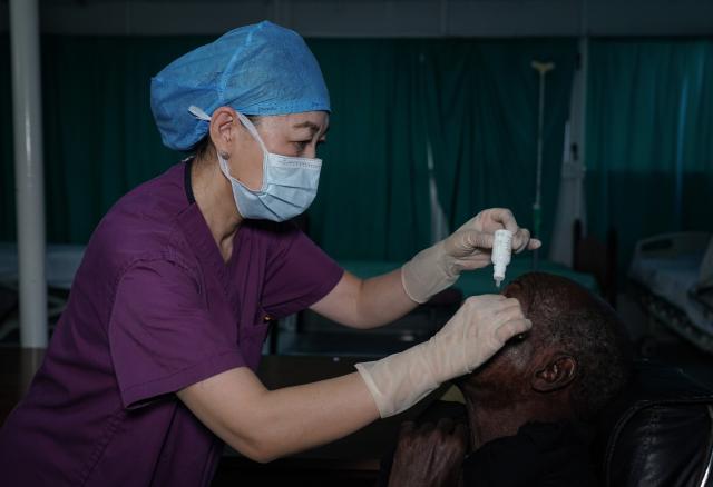 (250715) -- NOUAKCHOTT, July 15, 2025 (Xinhua) -- Wang Dongxia, a nurse with the 35th Chinese medical team to Mauritania, applies eye drops to a patient at the National Hospital in Nouakchott, Mauritania, on July 14, 2025. Since 1968, China has sent 35 batches of medical teams to Mauritania with more than 800 medical workers involved. The 35th Chinese medical team, consisting of 21 members, arrived in Mauritania in May 2023. (Xinhua/Han Xu)