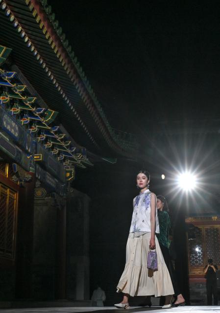 (250715) -- BEIJING, July 15, 2025 (Xinhua) -- A model presents a neo-Chinese ready-to-wear design during a fashion show held at the Prince Kung's Palace Museum in Beijing, capital of China, July 14, 2025. The fashion show is inspired by elements of the Prince Kung's Palace Museum and Chinese intangible cultural heritages, displaying 37 concept creations as well as 35 neo-Chinese ready-to-wear and accessories. (Xinhua/Jin Liangkuai)